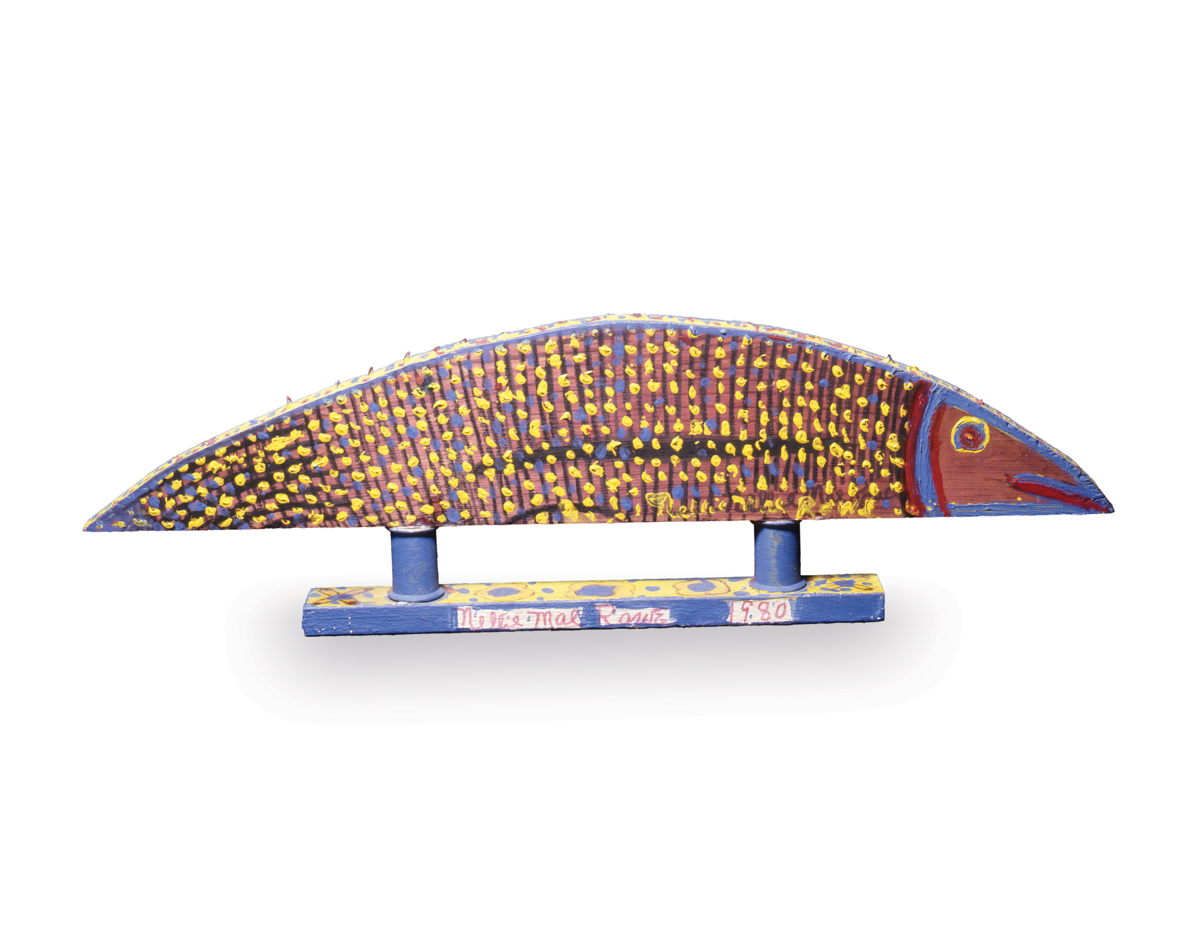 Wooden sculpture of fish with straight, flat bottom and smooth, sloped top painted red and black with yellow and blue dots; two short pillars attach fish to blue base.